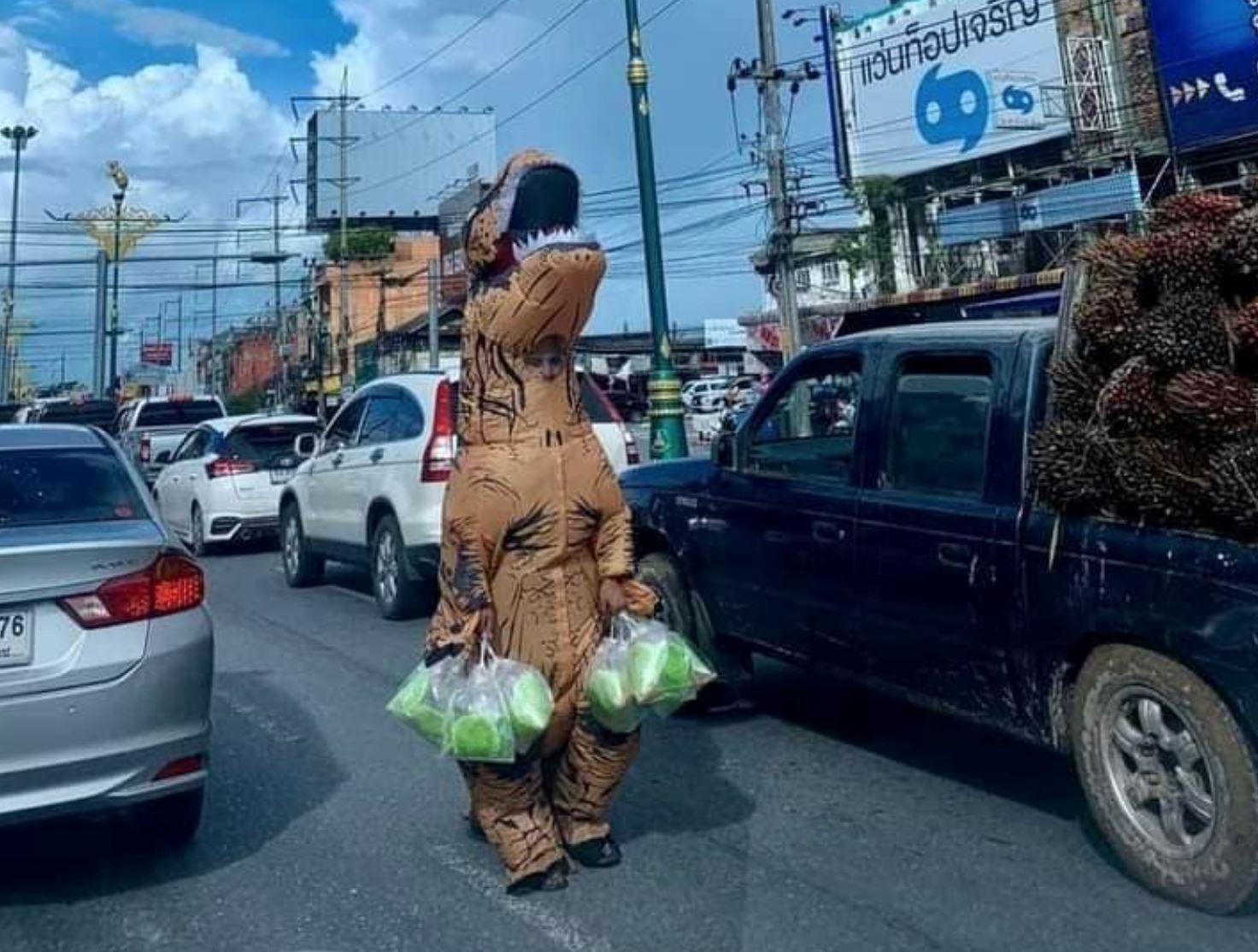 thai police criticized for banning food vendors in dinosaur costume