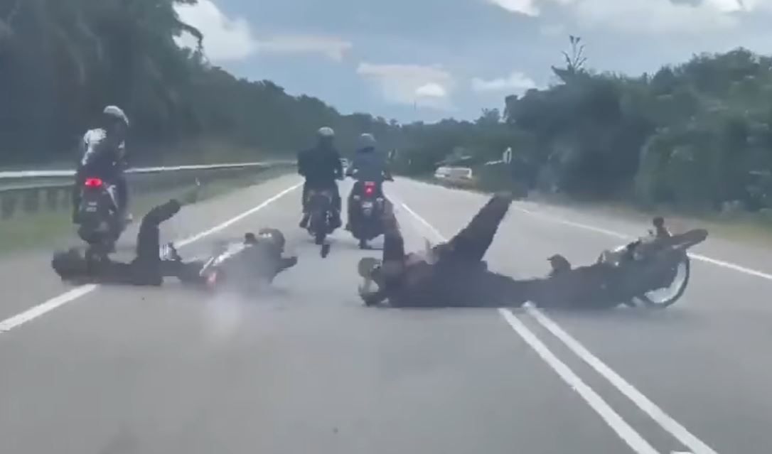 malaysians angered by motorcyclists talking to each other while on the road causing accident