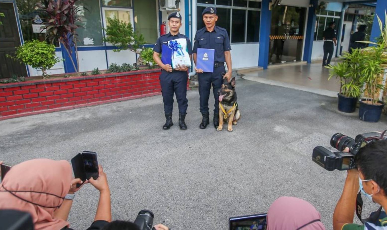 police in perak honors k-9 police with medal & kibbles for locating missing senior citizen