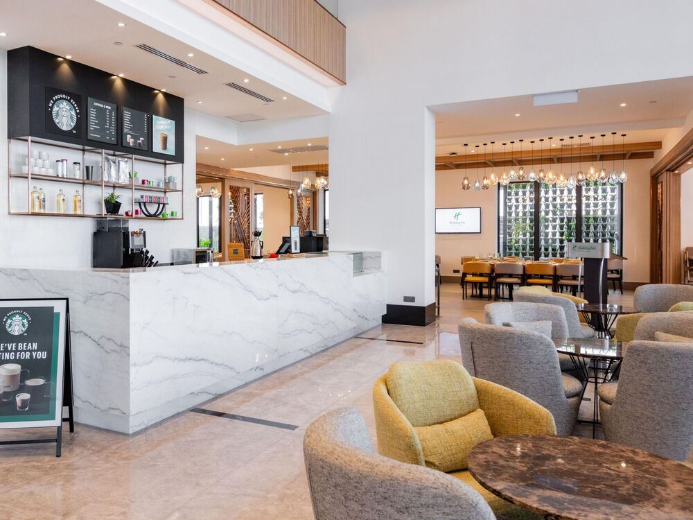 a room with a bar top and chairs around