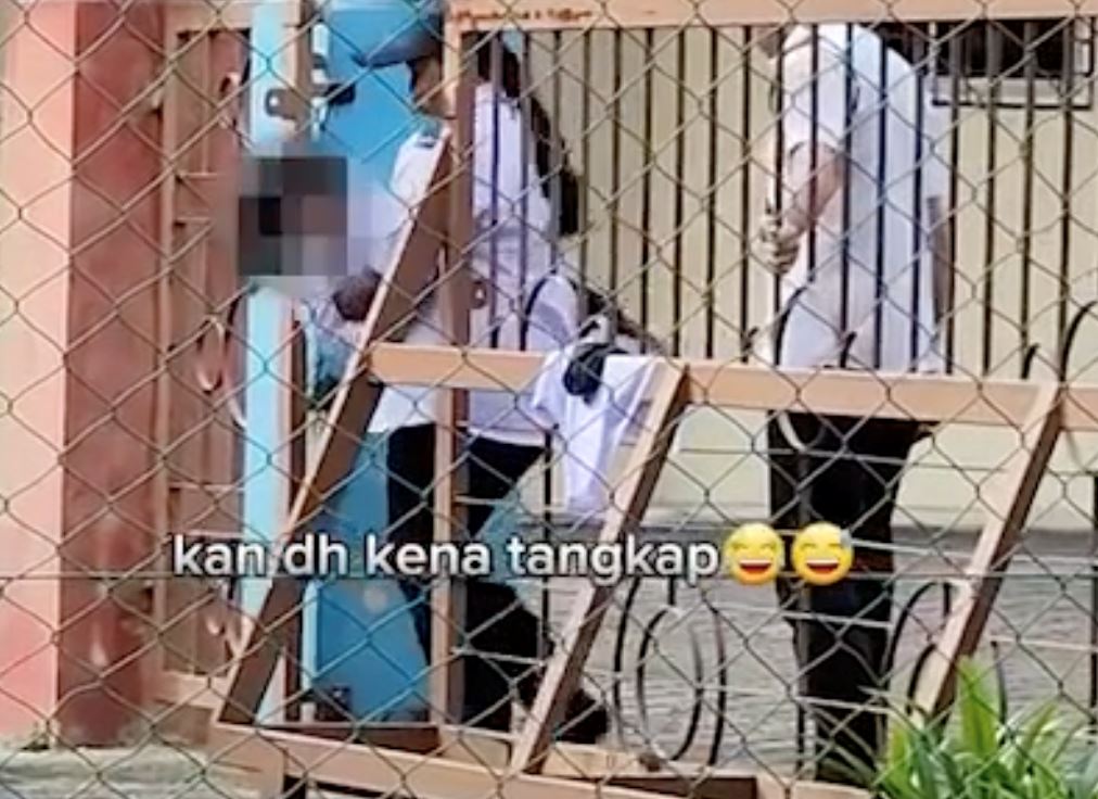 primary school student tries to “ponteng” by climbing through gate, caught by guards