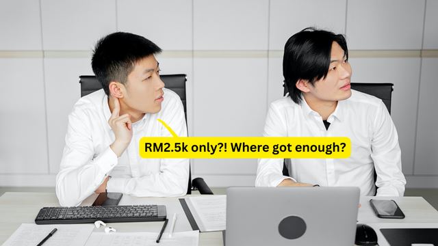 Two Asian men at work looking puzzled