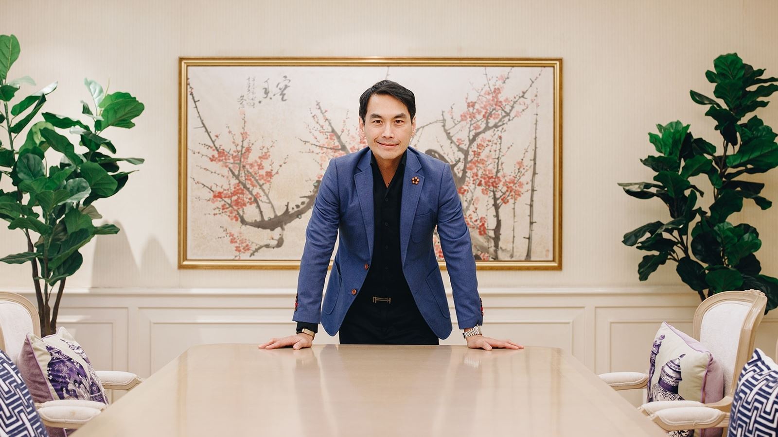 An image of a man dressed in a suit posing for the camera