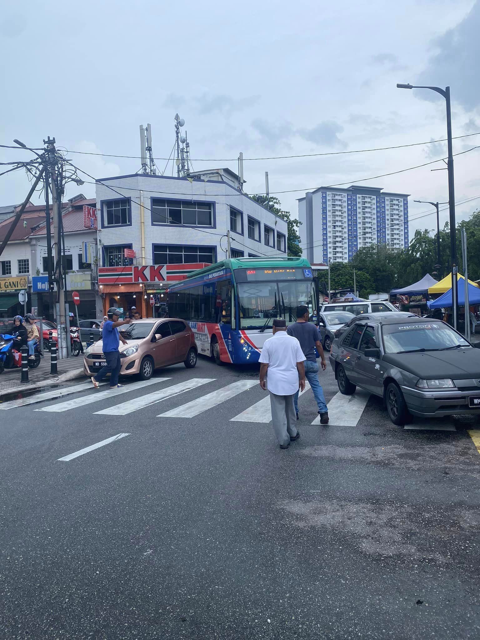 malaysians band together to physically lift and move parked car blocking bus's way
