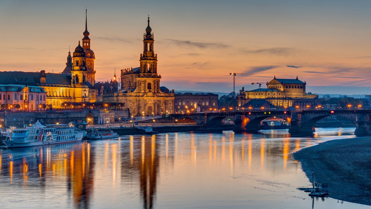 Lit up buildings by the river
