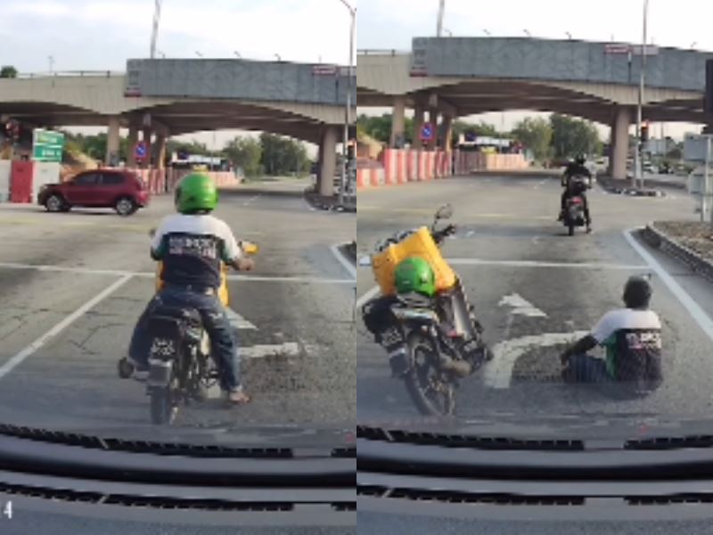 confused motorist encounters man sitting in the middle of kajang road at traffic light