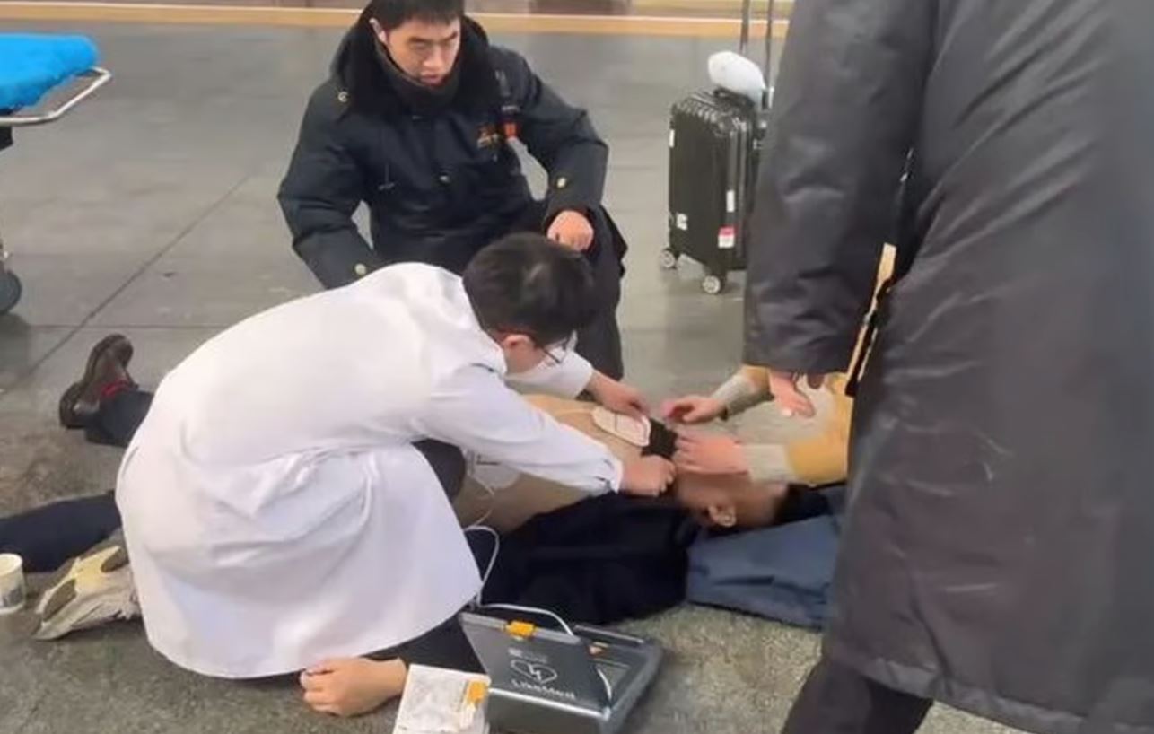 man in china suffers heart attack at train station, insists on going to work instead of hospital