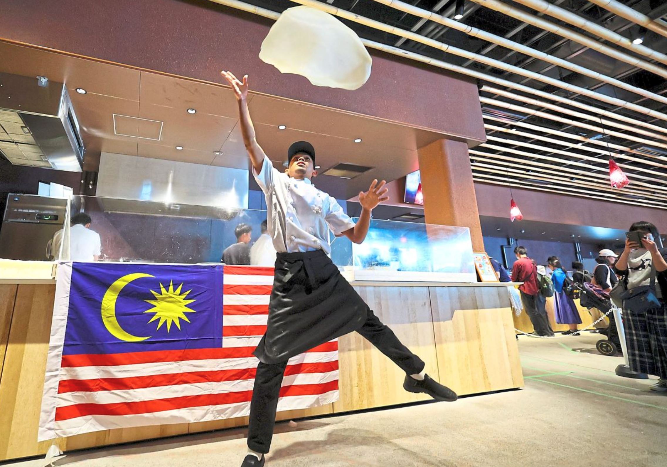 visitors line up for hours to watch malaysia’s flying roti canai at expo 2025 osaka