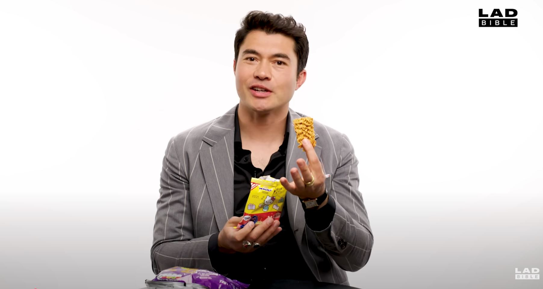 henry golding shows his true malaysian side in snack face-off against british favourites